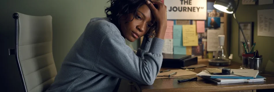 stressed individual sitting at a desk, reflecting the struggle with career burnout and the desire to rediscover life purpose